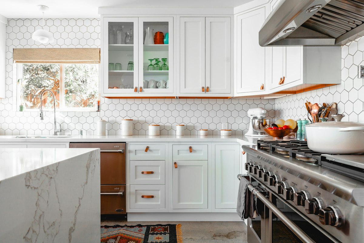 White kitchen with copper range and brass details